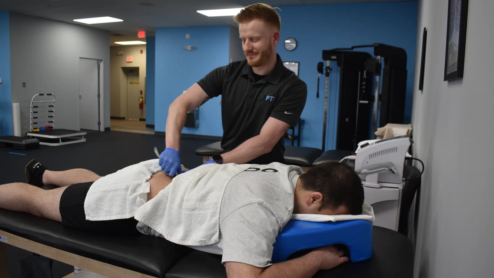 A 3PT Glen Ellyn physical therapist performing hands-on soft-tissue treatment on a patient at the clinic.