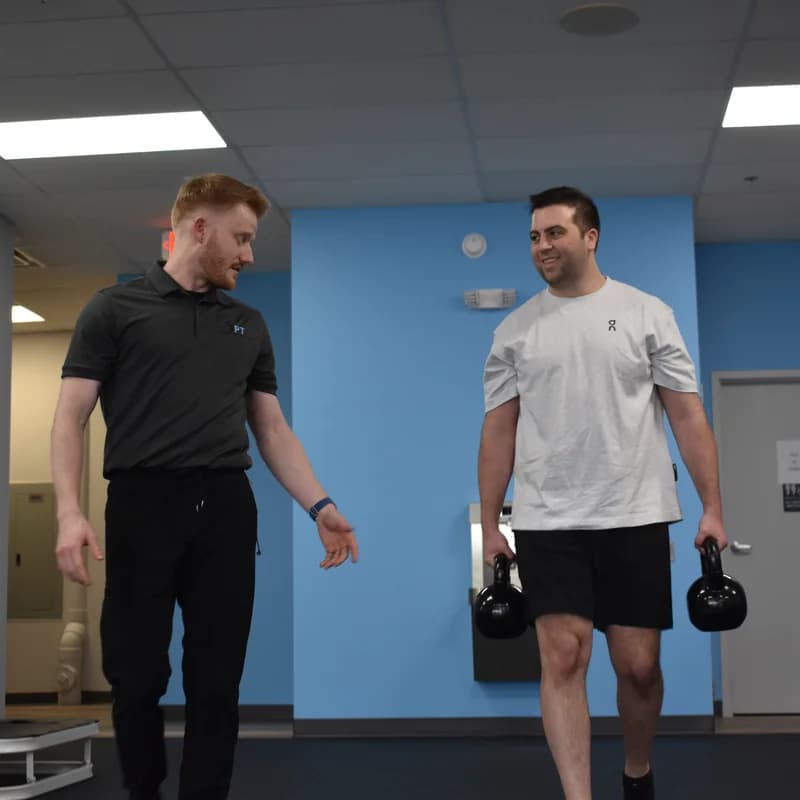 Interior view of the 3PT La Grange physical therapy clinic gym floor with natural light from the storefront window.