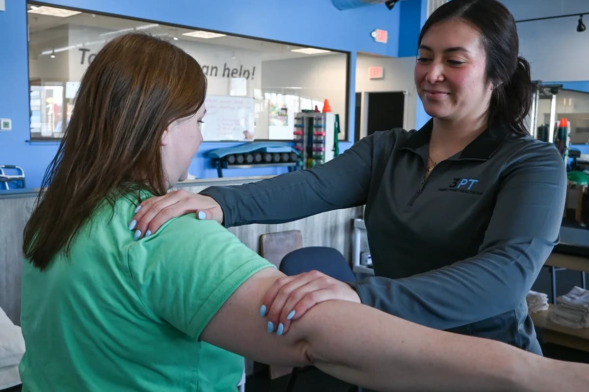 A 3PT Mokena physical therapist performing hands-on manual therapy on a patient's arm at the clinic.